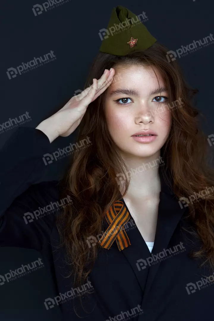 Free Premium Stock Photos A young woman in a black suit and a green military cap with a red star