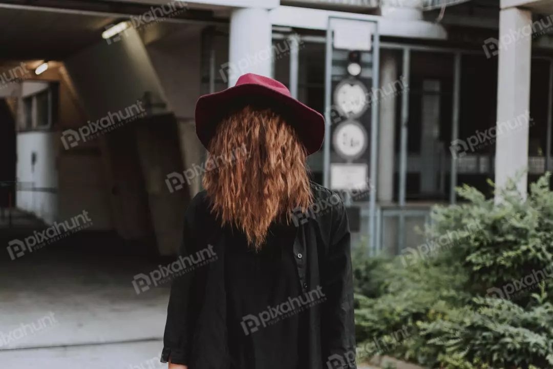 Free Premium Stock Photos Her face is obscured by her hat, which adds to the sense of mystery.