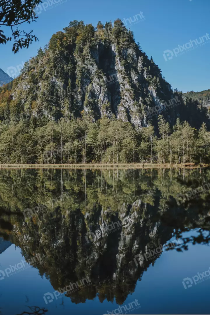 Free Premium Stock Photos water in front of the mountain is calm and still, reflecting the mountain perfectly