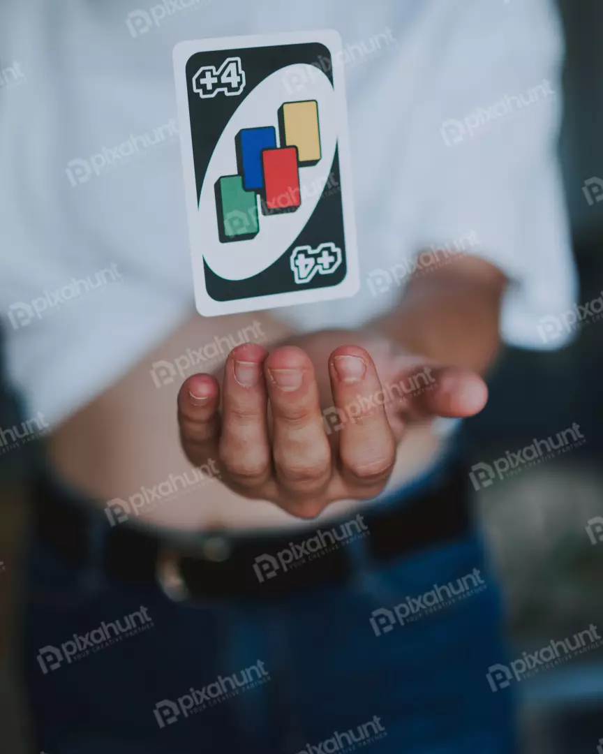 Free Premium Stock Photos A close-up of a person's hand holding a Uno card