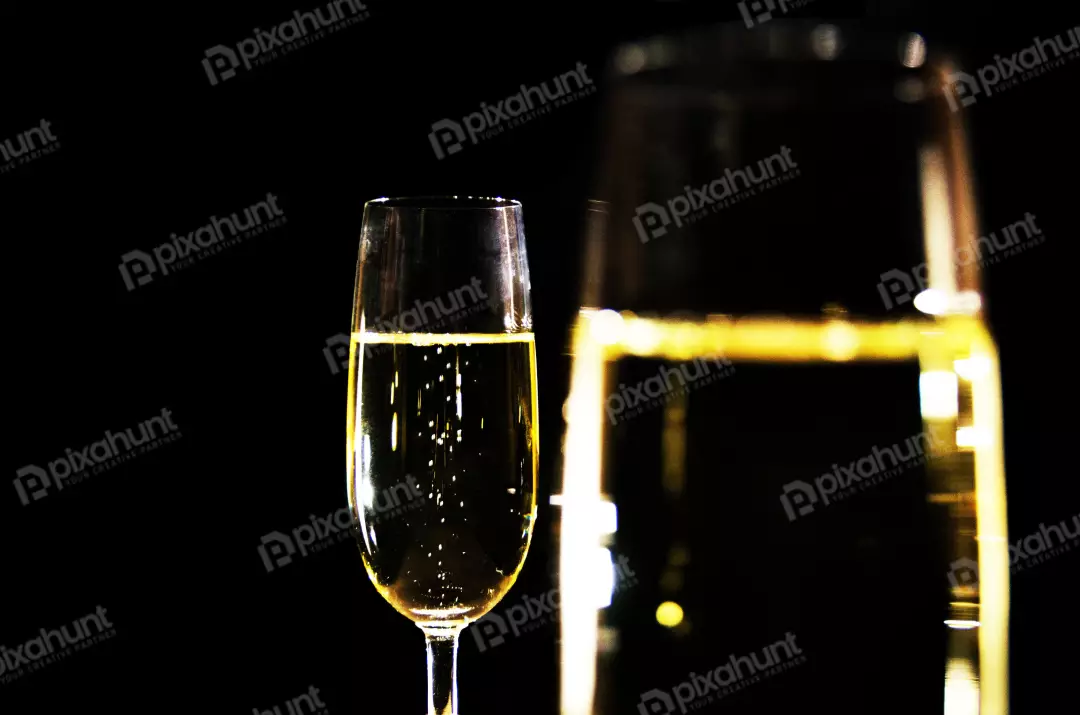 Free Premium Stock Photos A still life of a champagne glass and a champagne bottle on a black background