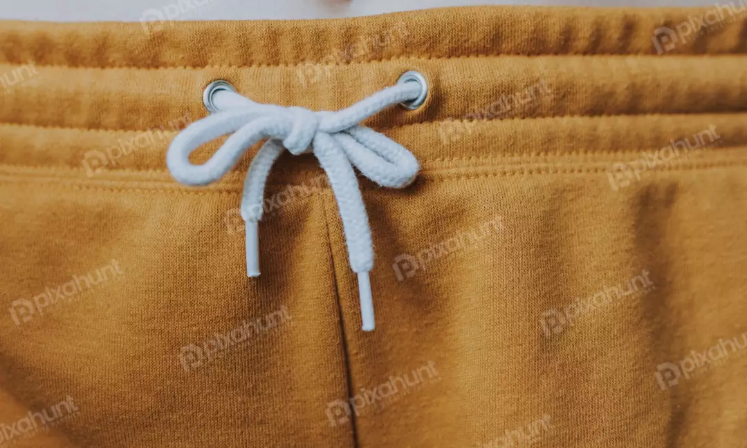 Free Premium Stock Photos a mustard yellow drawstring waistband with a white drawstring