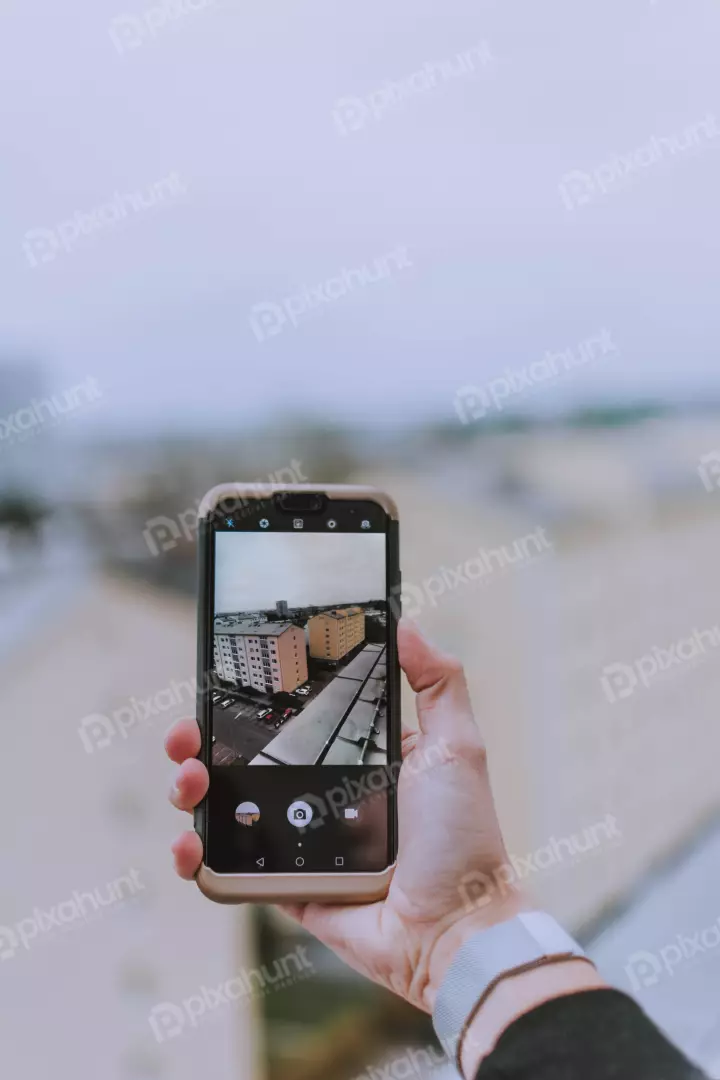 Free Premium Stock Photos a person holding a smartphone in their hand