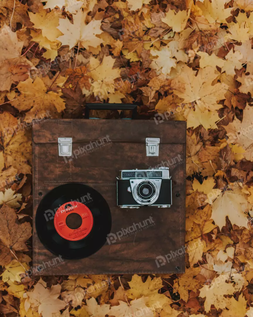 Free Premium Stock Photos a flat lay of a brown leather case with a camera and a vinyl record on top of it