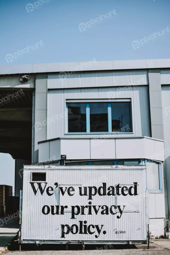 Free Premium Stock Photos A white corrugated metal container with black lettering that reads We've updated our privacy policy