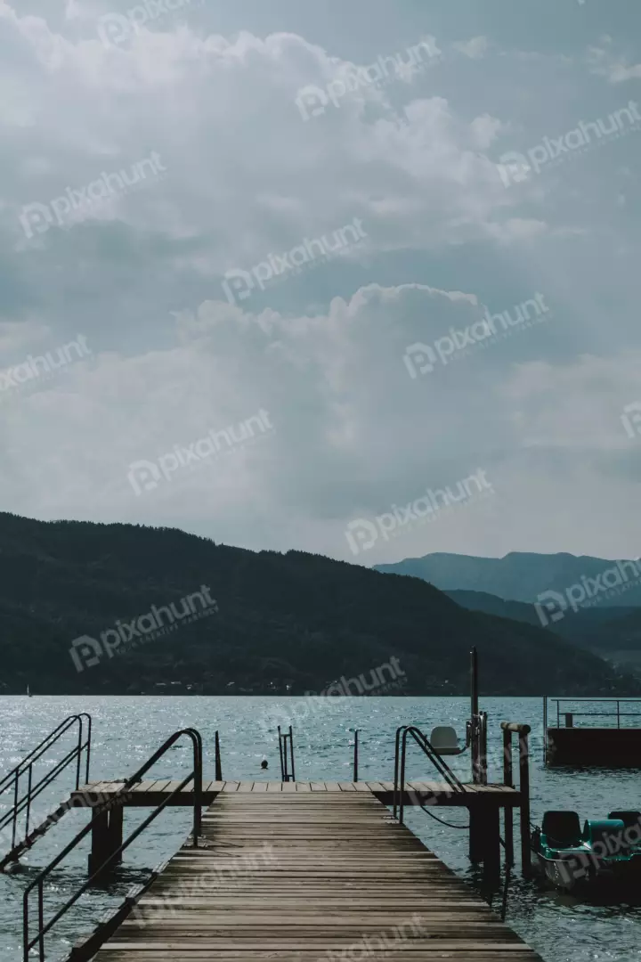 Free Premium Stock Photos The foreground is dominated by a wooden dock, which is wet from the rain