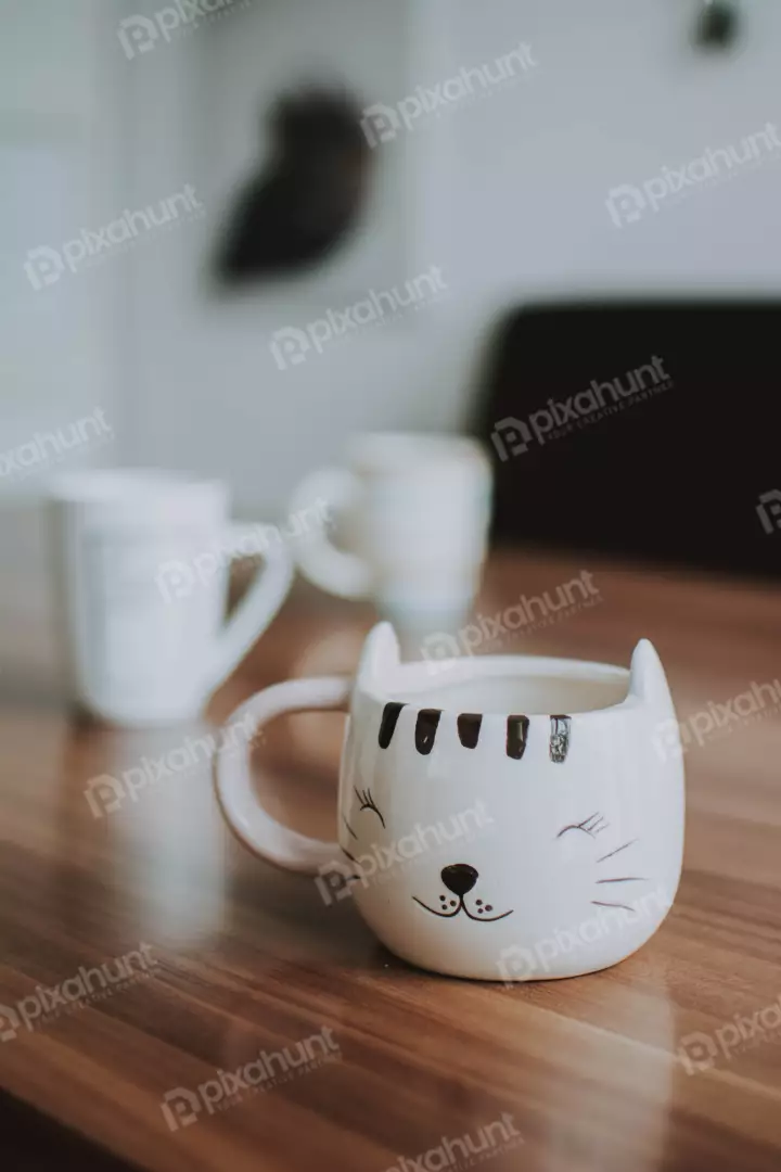 Free Premium Stock Photos a close-up of a white cat mug on a wooden table