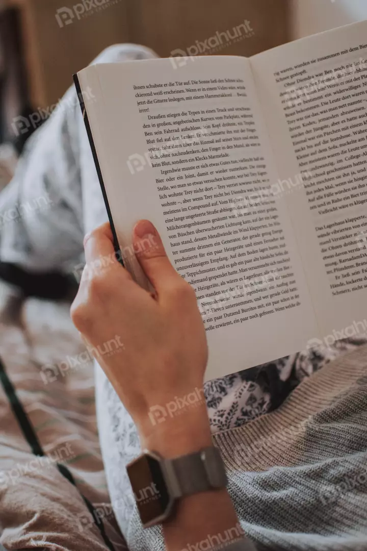 Free Premium Stock Photos A person holding a book in their hand