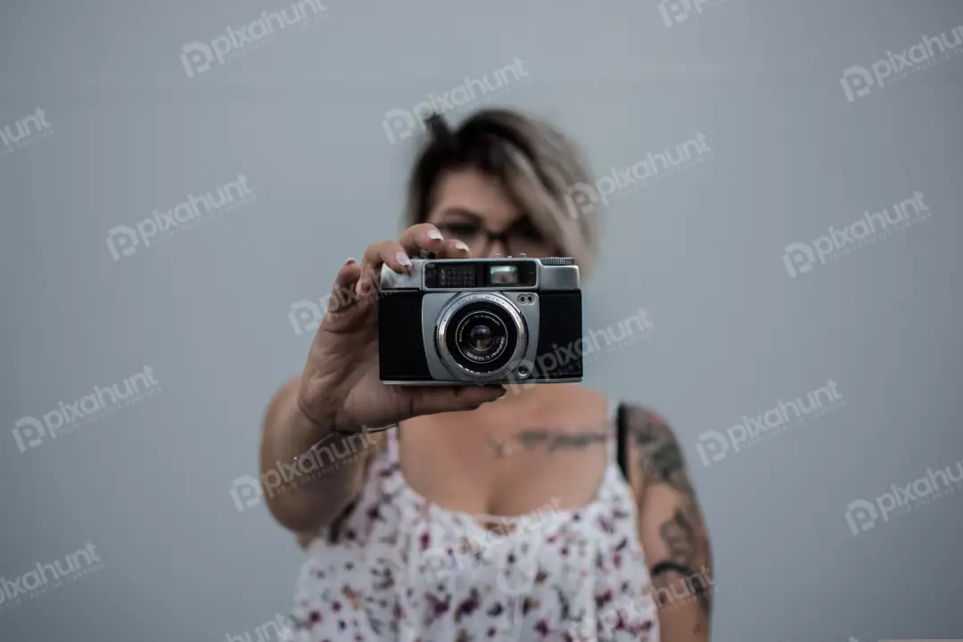 Free Premium Stock Photos The woman is holding the camera in front of her face