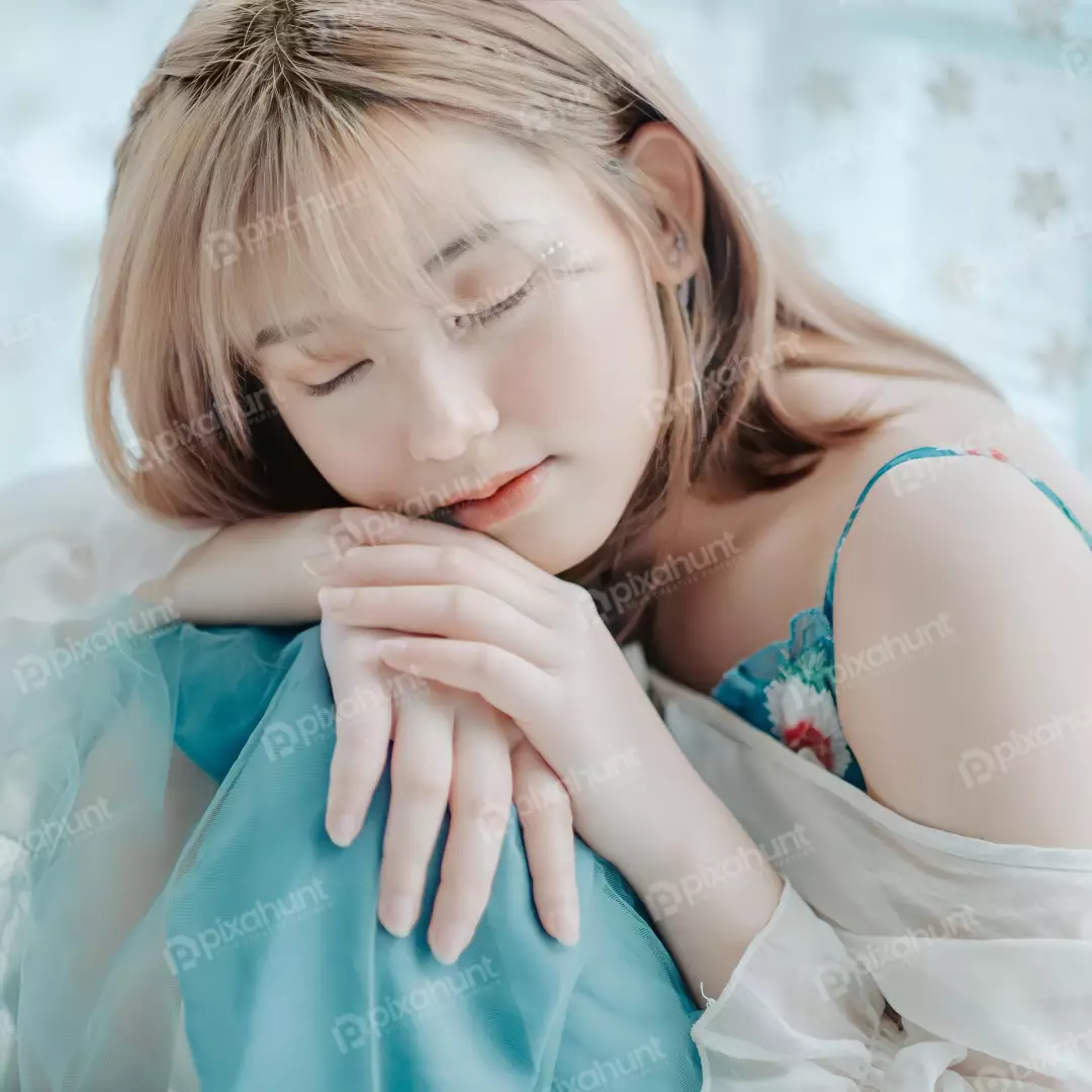 Free Premium Stock Photos Young Girl is sitting with her eyes closed and her hands folded in her lap looking like she is sleeping