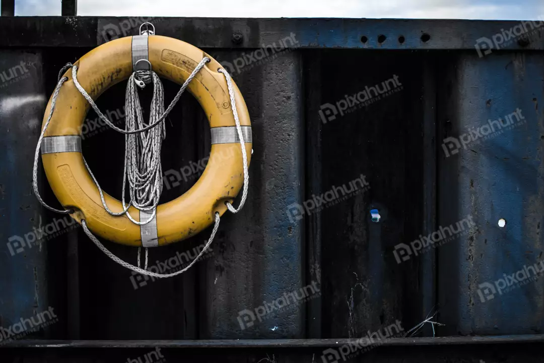 Free Premium Stock Photos Lifebuoy is hanging on a rusty metal wall