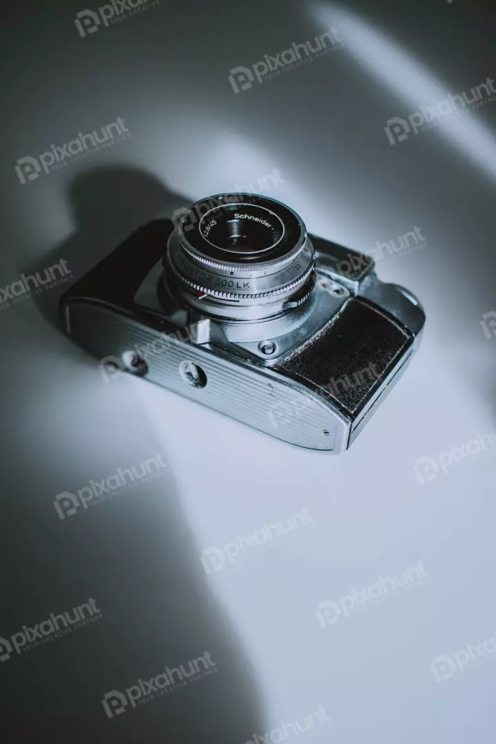 Free Premium Stock Photos a close-up of a vintage camera is lying on a white surface