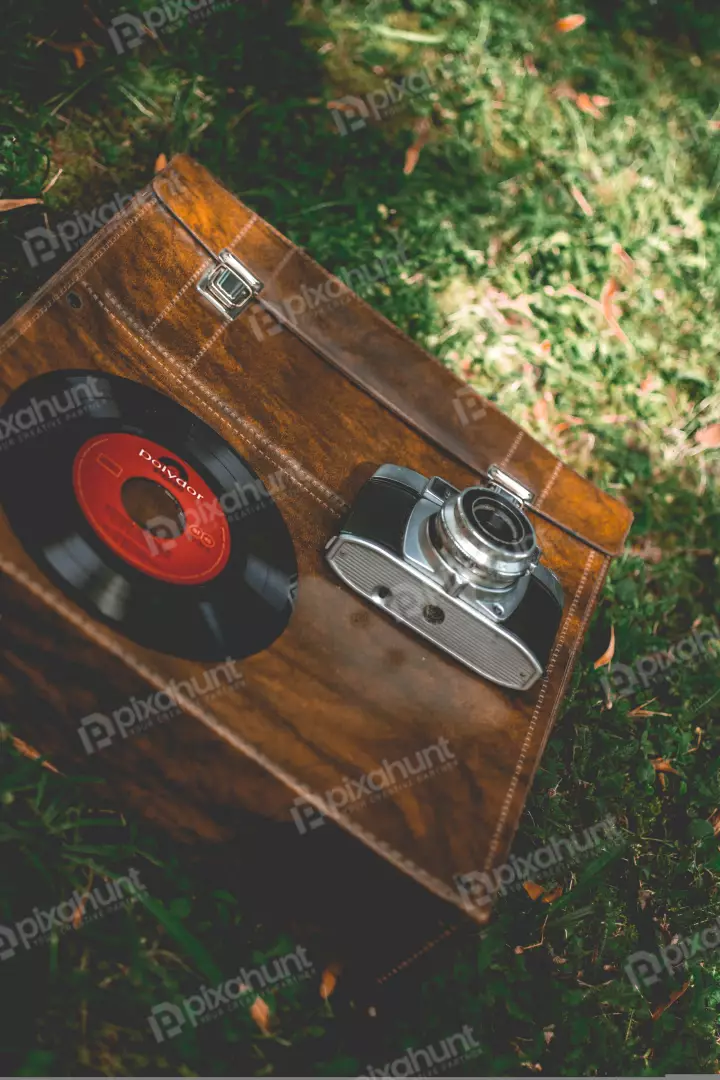 Free Premium Stock Photos a vintage camera and record player sitting on the grass