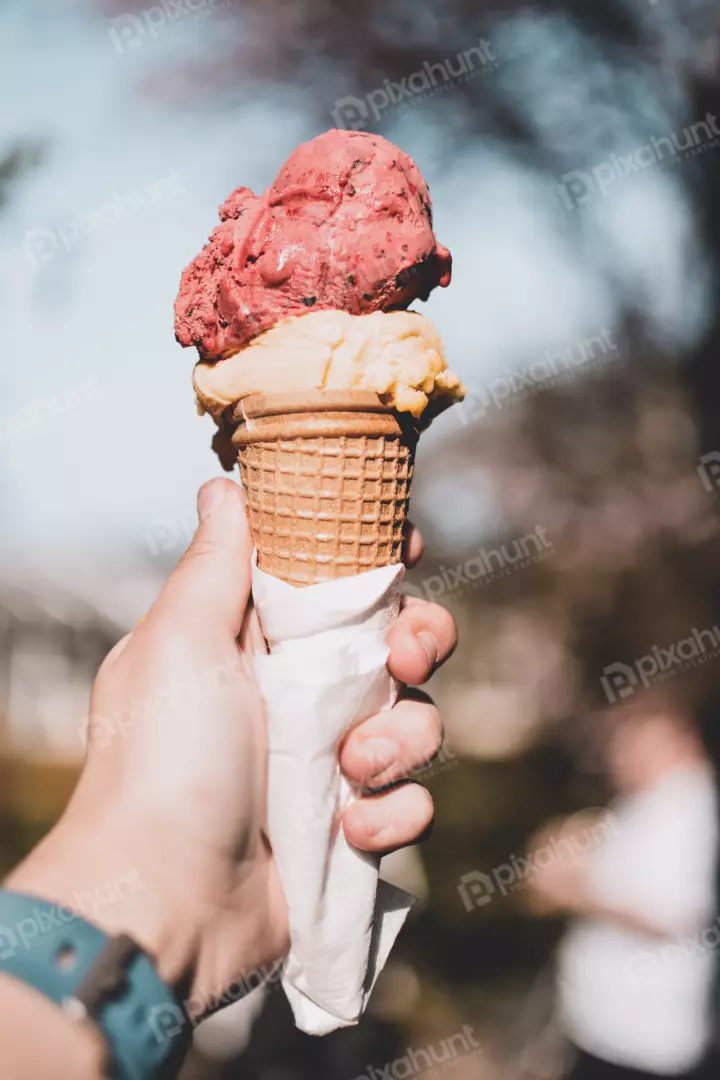 Free Premium Stock Photos a close-up of a hand holding an ice cream cone