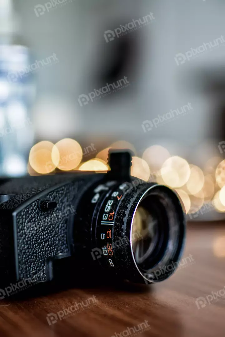 Free Premium Stock Photos The camera is positioned on a table, pointed at a string of lights in the background