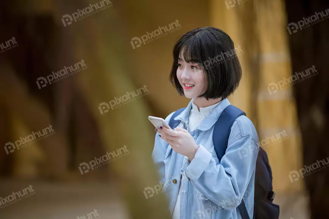 Free Premium Stock Photos Girl standing in a street looking at her phone