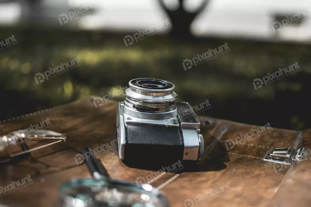 Free Premium Stock Photos a close-up of a vintage camera lying on a brown leather surface