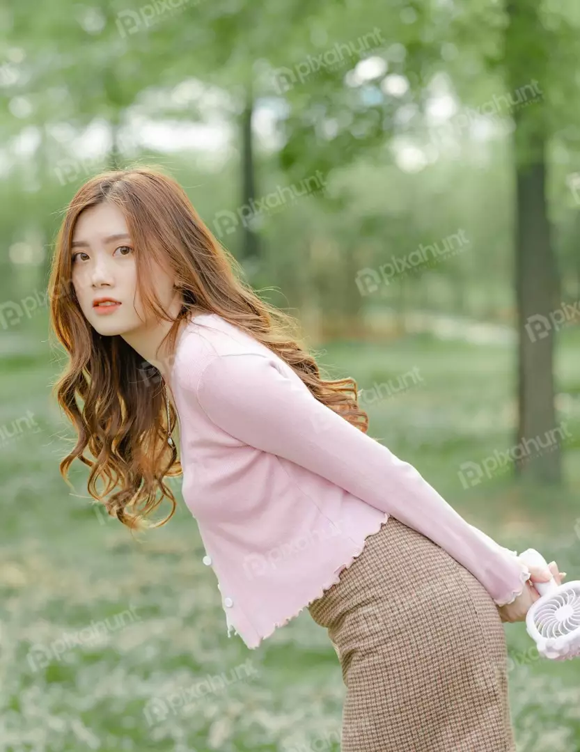 Free Premium Stock Photos A young woman standing in a park