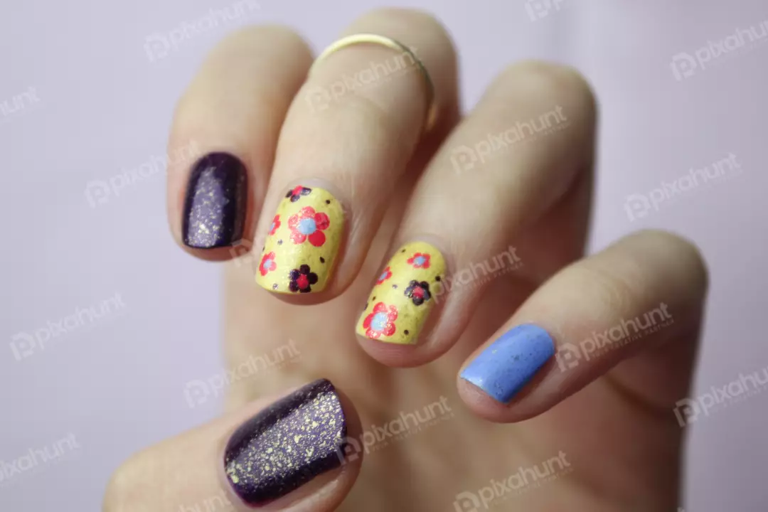 Free Premium Stock Photos A close-up of a hand with a floral nail design