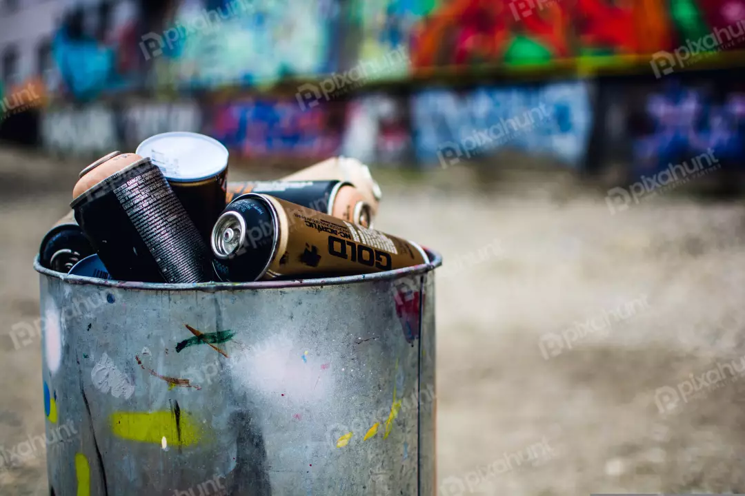 Free Premium Stock Photos a close-up of a trash can filled with spray paint cans