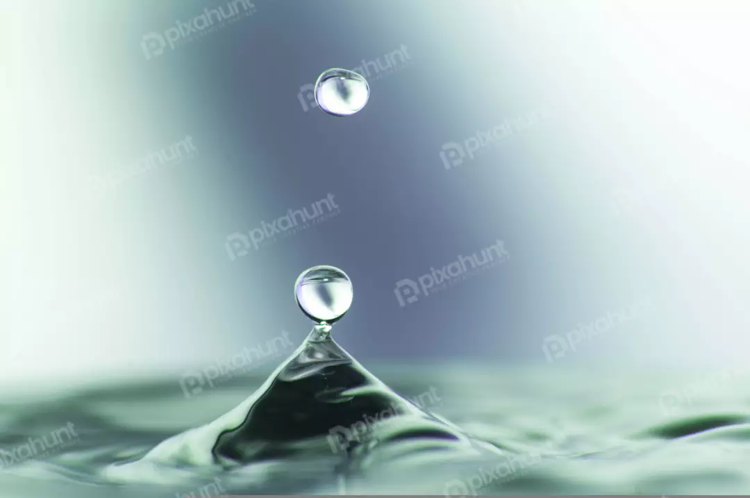 Free Premium Stock Photos The droplet is perfectly round and is suspended in mid-air