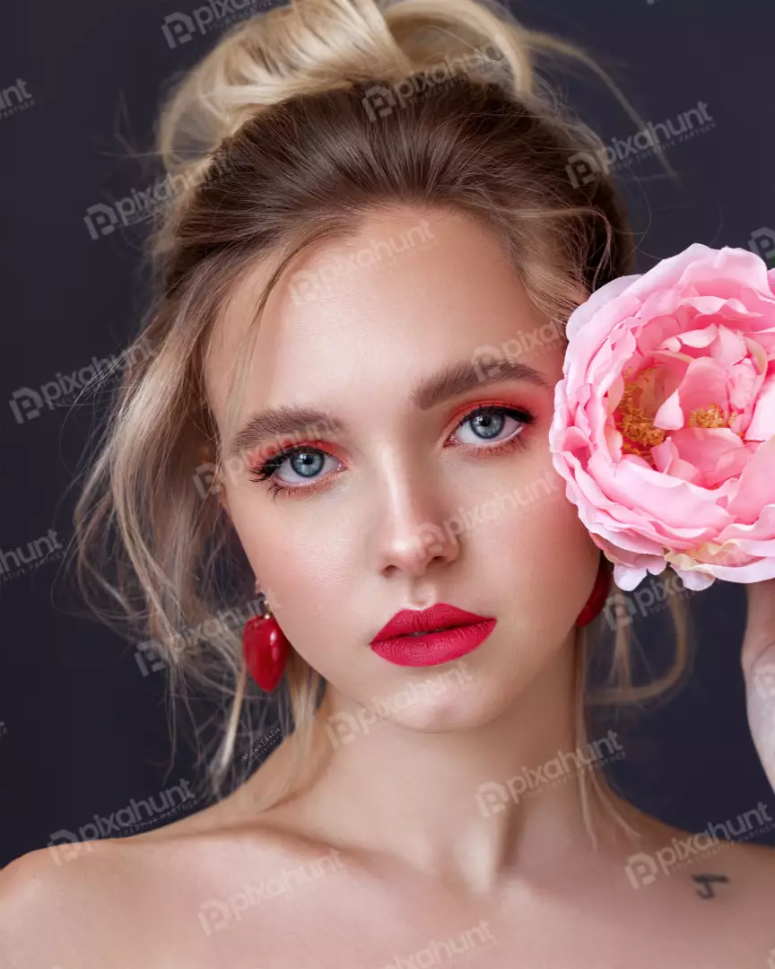 Free Premium Stock Photos A young woman with blonde hair and blue eyes also She is wearing a pink flower in her hair and has bright pink lipstick on