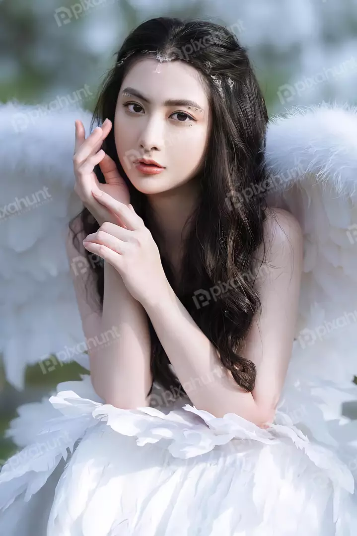 Free Premium Stock Photos A young woman with long black hair and white wings