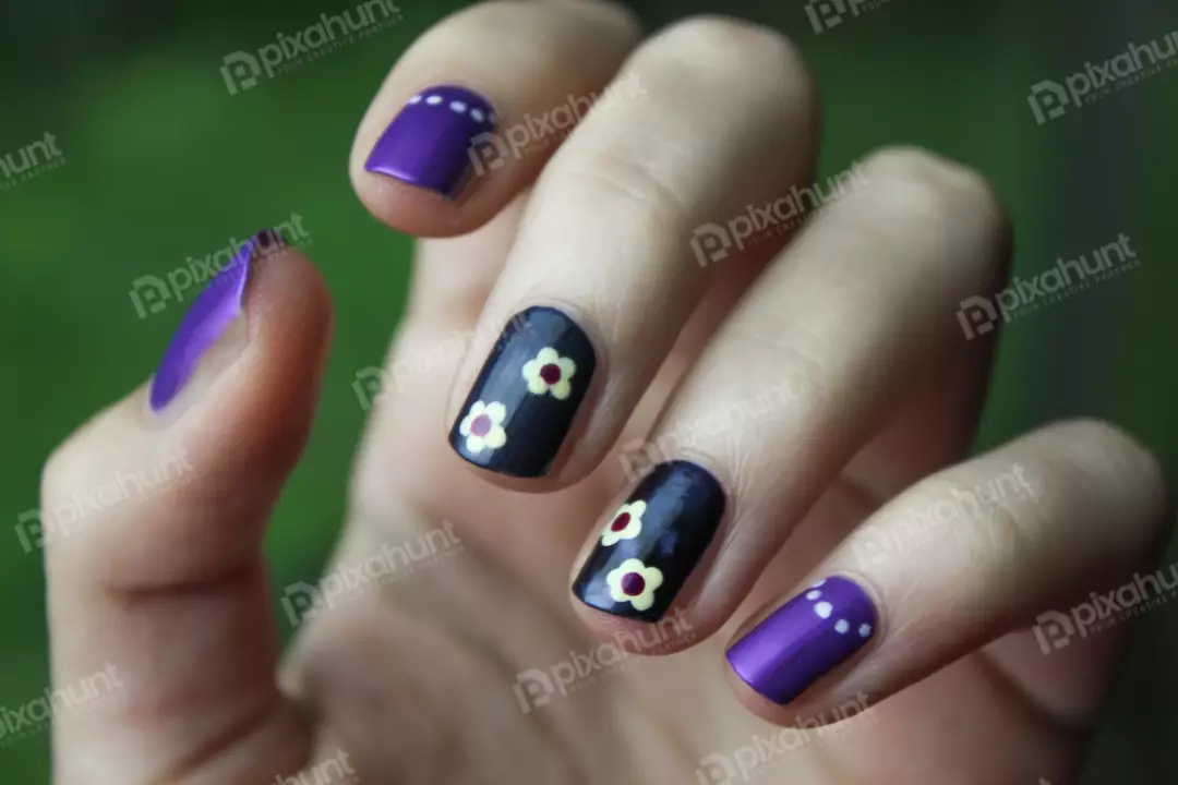 Free Premium Stock Photos a hand with a dark purple painted thumb and middle finger, with the index and pinkie painted a lighter shade of purple