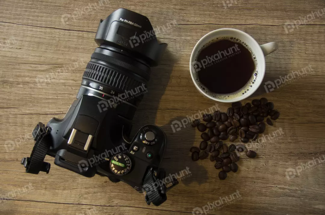 Free Premium Stock Photos A flat lay of a camera and a cup of coffee, and coffee beans on a wooden table