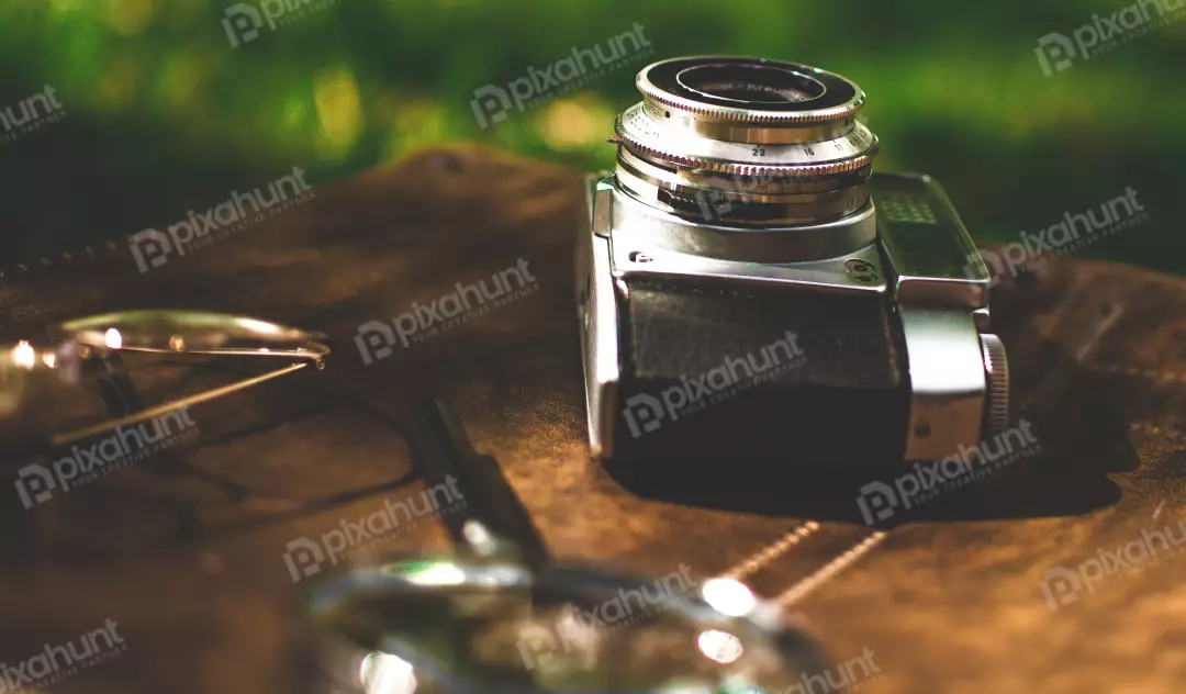 Free Premium Stock Photos an old camera on a brown leather surface