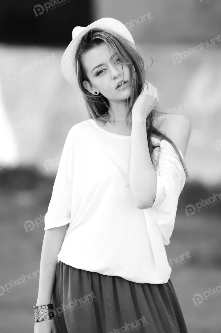 Free Premium Stock Photos Black and white young woman is wearing a white shirt, a hat, and a skirt