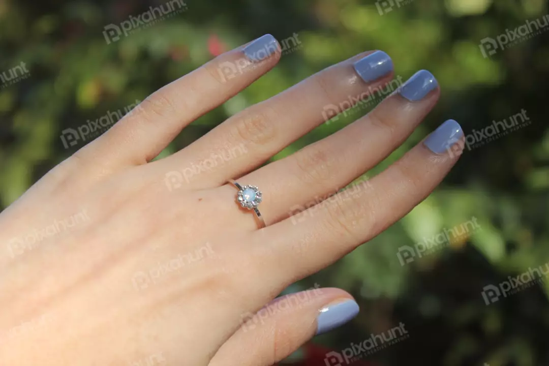 Free Premium Stock Photos A close-up of a woman's hand Also woman is wearing a silver ring with a clear stone on her middle finger