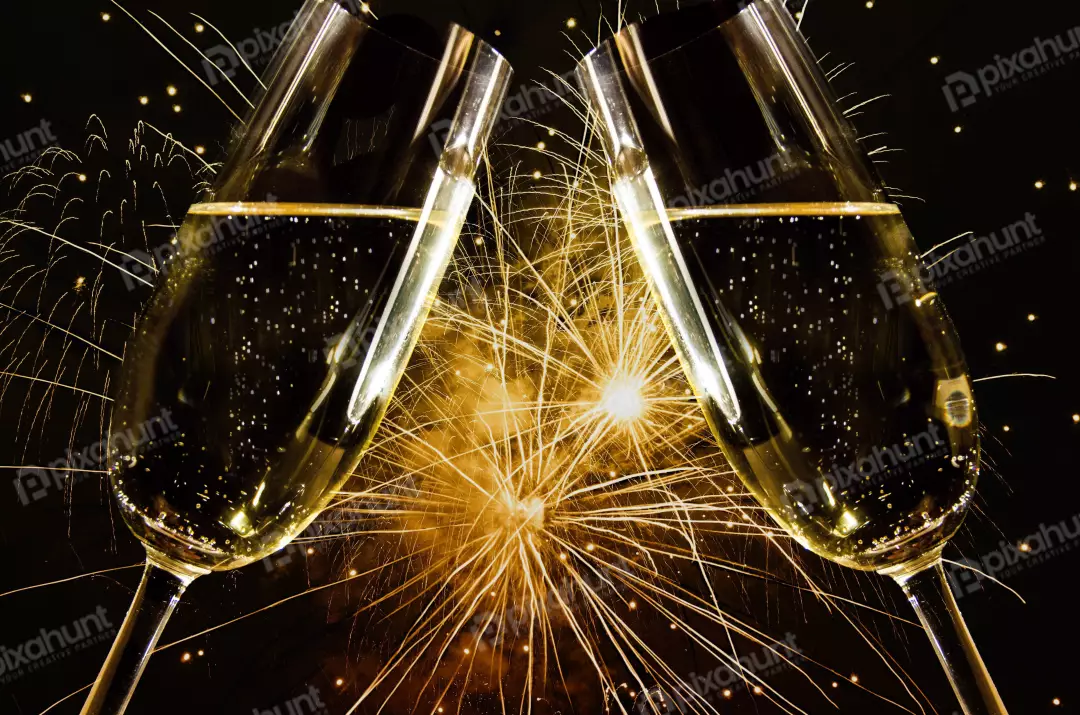 Free Premium Stock Photos A celebration of New Year's Eve two champagne glasses with a beautiful golden fireworks display