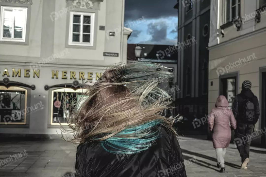 Free Premium Stock Photos A woman with long, dark hair that is blowing in the wind