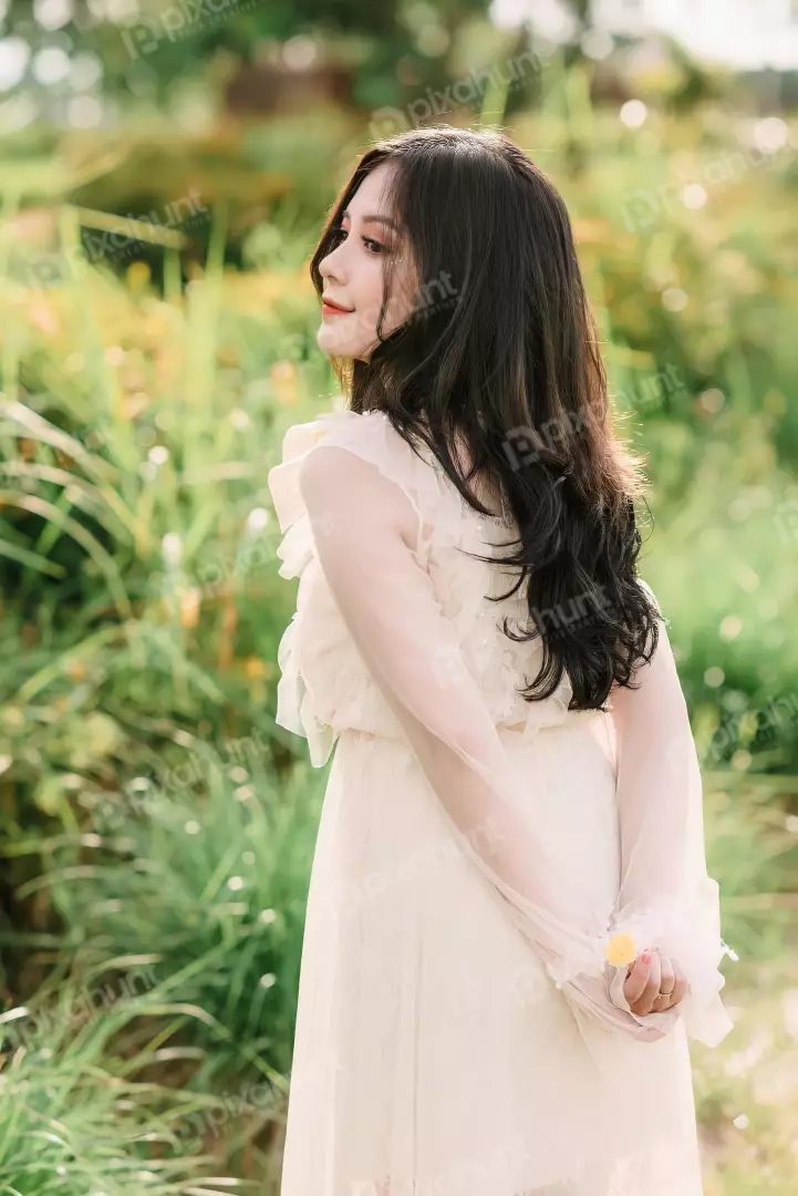 Free Premium Stock Photos Girl is wearing a beautiful white dress and has long flowing hair is standing in a field of tall grass and looks to be enjoying the sunshine