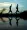 Two women doing yoga on a beach at sunset