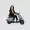 Kamala Harris riding a scooter and She is wearing a suit and heels