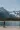 looking up at a man standing on the shore of a lake