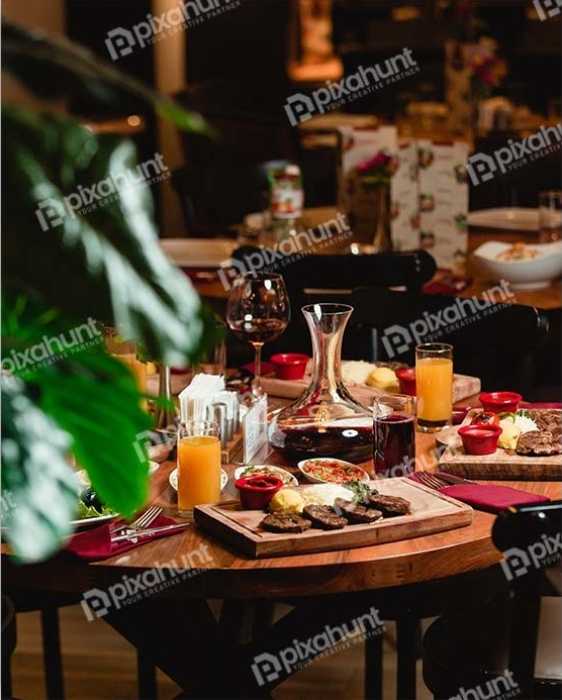 Free Download Premium Stock Photos | Table On foods With soft drinks | A dinner table with foods and soft drinks in a restaurant
