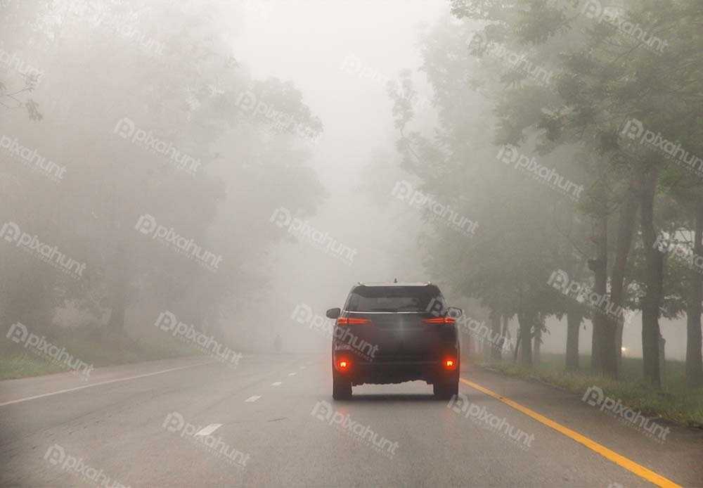 Free Download Premium Stock Photos | Blurred hard foggy road with detail of car light, transportation concept
