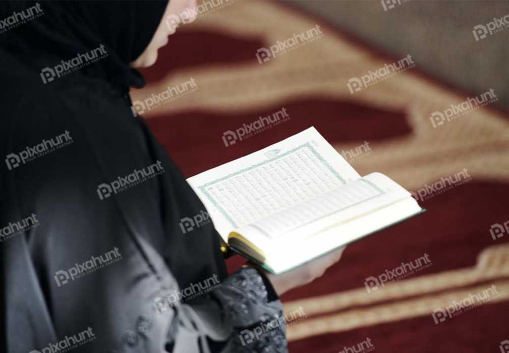 Free Download Premium Stock Photos | Muslim Arabic Woman Sitting And Reading Holy Book Koran