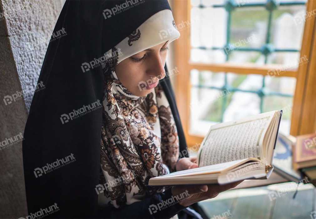 Free Download Premium Stock Photos | Reading a book near a window. Unfortunately, the person face is not visible due to blurring.