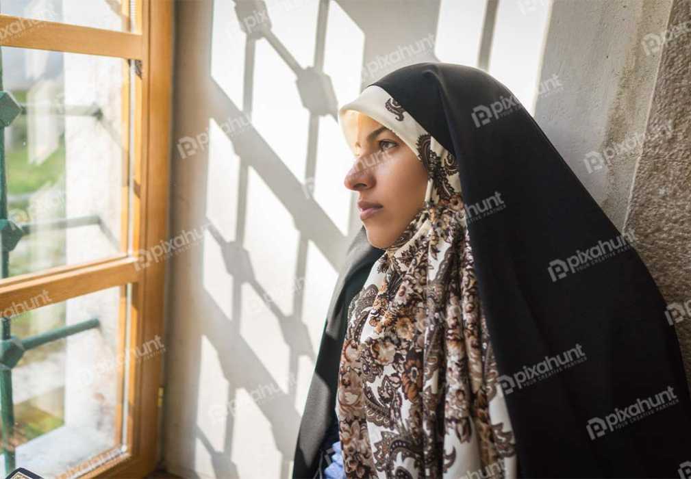 Free Download Premium Stock Photos | Muslim Woman reading quran islamic holy book after praying